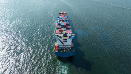 cargo maritime ship with contrail in the ocean ship carrying container and running for export concept technology freight shipping by ship smart service forwarder. stern container ship