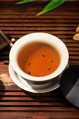 Brewing black tea in ceramic gaiwan during the tea ceremony close-up. 