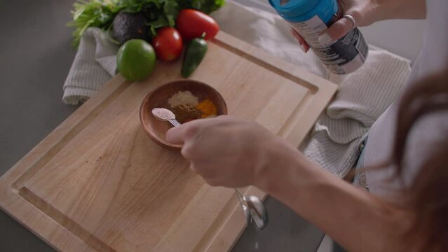 Preparing spices in mixing bowl, modern kitchen