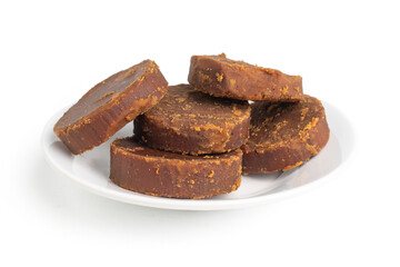 cylindrical dark brown sugar or palm sugar isolated on white background