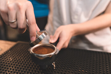barista making a coffee from coffee powder. closeup of small business of coffee shop.