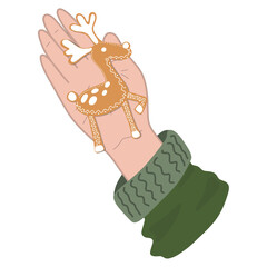 Obraz premium a hand with a Christmas gingerbread in the form of a deer