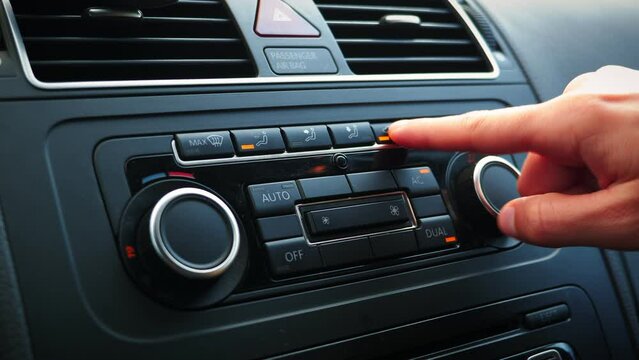 Turning on air recirculation buttons in car. Pressing car air conditioner switch