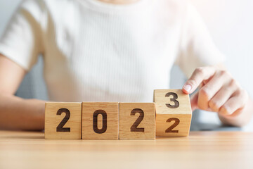 2022 change to 2023 year block on table. goal, Resolution, strategy, plan, start, budget, mission, action, motivation and New Year concepts - obrazy, fototapety, plakaty
