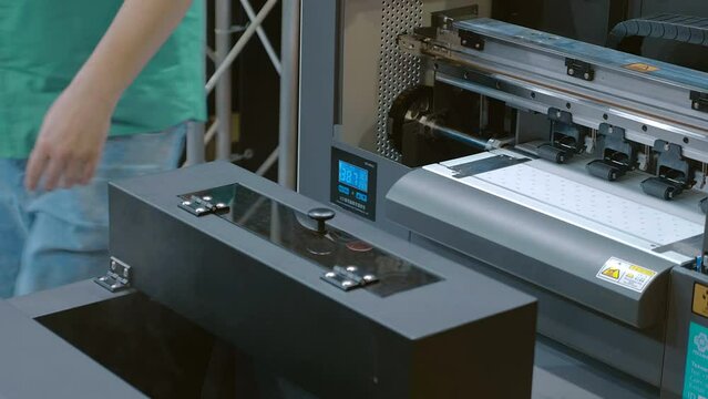 Equipment for printing paint on fabric and then drying it. Monitor for controlling the drying process of paint on a T-shirt. Closeup