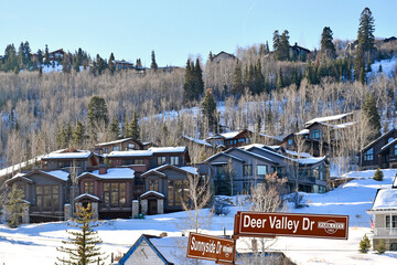 Vacation homes on a snowy tree lined hillside in the Park City and Deer Valley ski areas during...