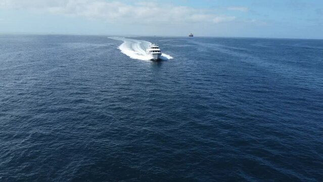 Long Beach Aerial of Expensive Super Yacht flying through the Pacific Ocean. Drone 4k