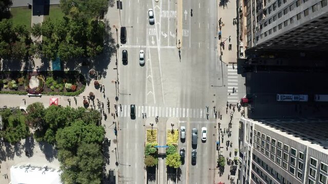 Corner of Michigan Avenue and Monroe Street in downtown Chicago, Illinois with drone video overhead showing traffic and pedestrians.