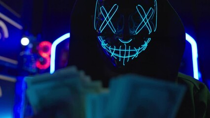 Male terrorists are hacking the security system. He counting money when success to hack data. - Powered by Adobe