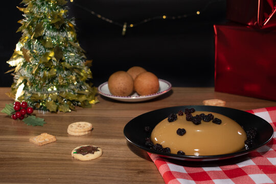 Traditional Colombian Christmas dinner, with bu&ntilde;uelos, natilla and cookies, wooden, black background