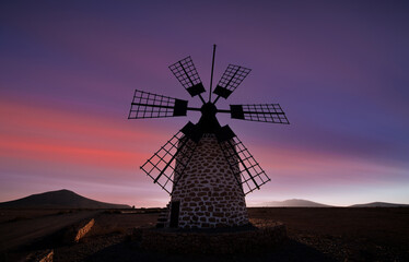 old windmill against the background of the sunset sky