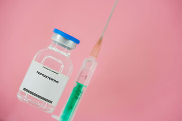 Testosterone. Test tube with artificial hormone on pink background Testosterone