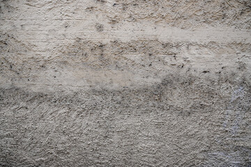 Graue Betonwand mit Putz als Hintergrund mit Textfreiraum