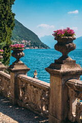 Beautiful old sculpture with flower columns in the botanical garden of the famous mediterranean Villa Monastero, in traditional village of Varenna, Province of Lecco, on the shore of Lake Como, Italy.