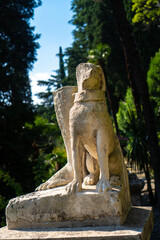 Ancient statue looks out to the lake from the botanical garden of the famous Villa Monastero in Varenna, Province of Lecco, Italy.