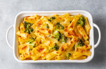 Pasta baked with broccoli and chicken. Broccoli, cheese and gratin sauce on baked penne pasta.