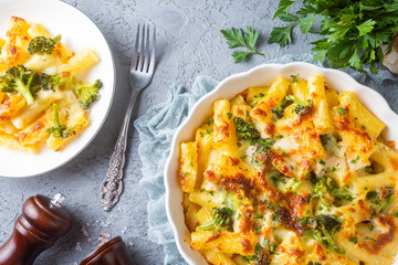 Pasta baked with broccoli and chicken. Broccoli, cheese and gratin sauce on baked penne pasta.