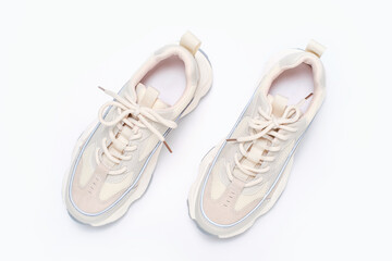 Pair of sneakers on white background close-up top view.