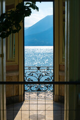 Scenic view of Lake Como and Alpine mountains visible from the chapel located in the botanical garden of Villa Monastero, Varenna, Province of Lecco, Italy.