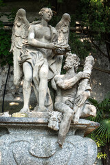 Beautiful ancient sculptures in the botanical garden of the famous Villa Monastero, located in traditional village of Varenna, Province of Lecco, on the shore of Lake Como, Italy.