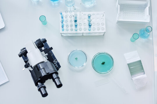 Above view of glassware, microscope and other equipment for carrying out new scientific investigation in clinical laboratory