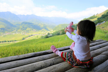 Little girl sitting on the bamboo house, cheer with View of Terraced rice field - SaPa, Vietnam....
