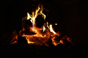 Background of the flame in the oven. Tongues of fire in a brick fireplace. Fire texture.
