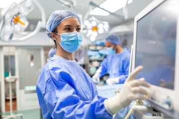 Concentrated Surgical team operating a patient in an operation theater. Well-trained...