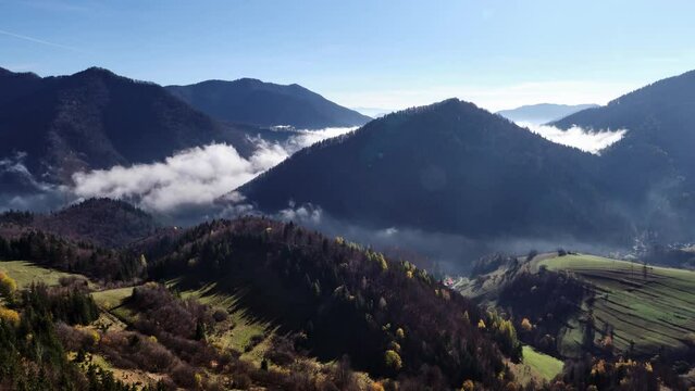 Hilly landscape shrouded in fog of low clouds