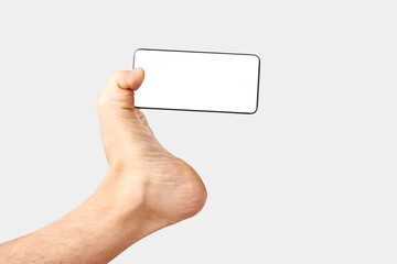 Man feet holding phone on white background