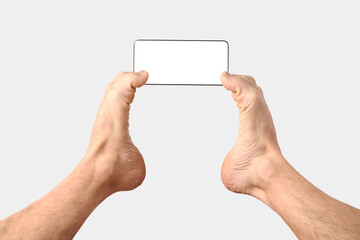 Man feet holding phone on white background