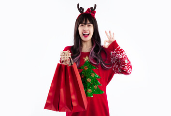 Asian woman in red sweatshirt christmas theme carrying shopping bags to celebrate christmas and new year white background.