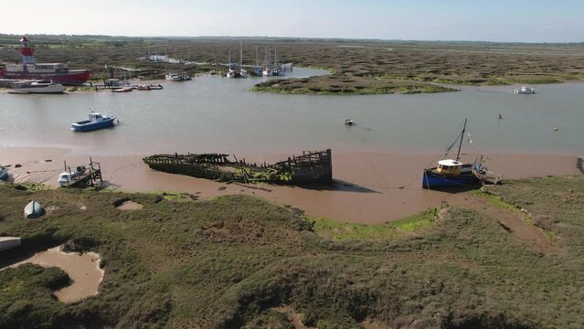 Destroyed Huge Ship Abandoned Near The Swamps In Tollesbury Marina, Essex, United Kingdom. Aerial Drone Shot