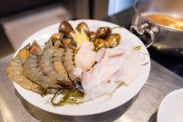 Fresh raw seafood in hot pot restaurant