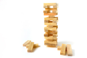 Board game made of wooden blocks. Tower of unevenly shifted wooden beams. A lesson in dexterity,...