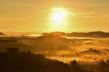 Mountain with fog and morning sunrise. 