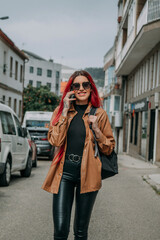 red-haired woman with mobile phone in the street