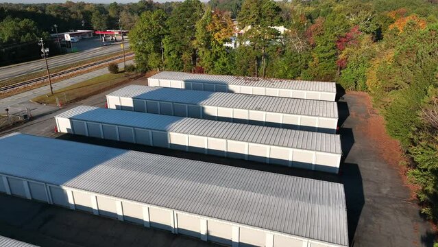 Self storage garage units in America. Aerial in autumn with colorful fall leaves.
