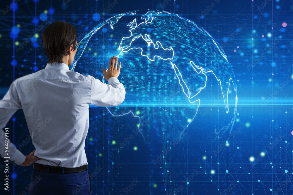 Poster Global network connection and big data concept with man back view touching digital screen with illuminated world map on blue background