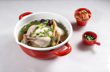 Sup Ayam Ginseng or Samgyetang is  Koreans traditional chicken soup made with young chicken using ginseng, jujube dates and sweet rice stuffing served with kimchi.