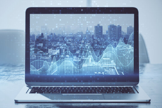 Close up of laptop screen with abstract glowing blue business graph on blurry city background. Financial growth, market and stock concept. 3D Rendering.