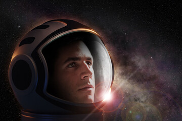 Head shot of astronaut wearing a helmet looking at the deep space. Concept of space travel and...