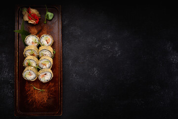 Sushi roll Banzai on a wooden board