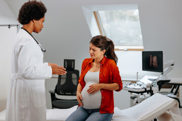Concerned pregnant woman at gynecologist.
