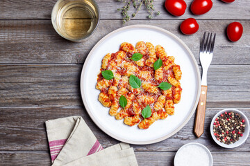 Gnocchi with tomato sauce, basil and Parmesan cheese. Healthy eating. Vegetarian food. Diet.