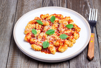 Gnocchi with tomato sauce, basil and Parmesan cheese. Healthy eating. Vegetarian food. Diet.