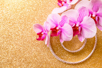 Fototapeta na wymiar Bracelet and necklace on a gold shiny background 