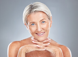 Face, beauty and skincare with a mature woman in studio on a gray background for antiaging treatment. Wellness, portrait and cosmetics with a senior female posing to promote a natural skin product