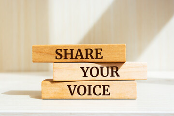 Wooden blocks with words 'Share Your Voice'.