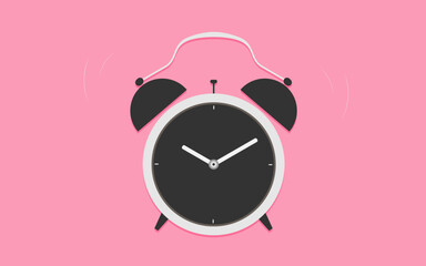 Classic alarm clock on pink background